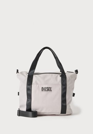 Helehall hall Diesel koti mustade käepidemete ja õlarihmaga, esitaskul Diesel logo.