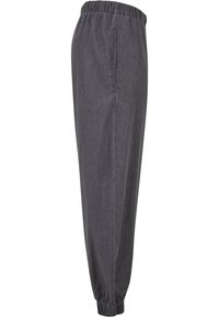 Gray elastic waistband pants with a tapered fit. Made of lightweight fabric featuring side pockets and elastic cuffs at the ankles.