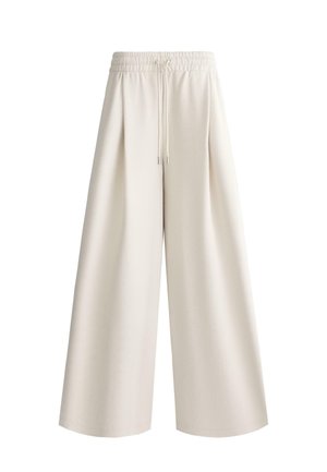 Wide-leg cream pants with elastic waistband and drawstring, loose fit extending straight from hips to hem.