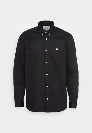 Black button-up shirt made of cotton with a pointed collar, long sleeves, and a small white logo on the left chest. Features white buttons.
