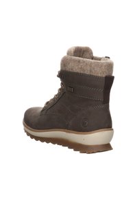 Brown ankle boot with a felt collar, rounded toe, and lace-up design. Features a thick rubber sole and decorative stitching accents.