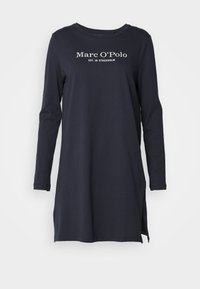 Tunic a maniche lunghe di colore blu navy realizzata in morbido cotone, con scollo rotondo e fessure laterali, con il logo bianco "Marc O'Polo" sul davanti.
