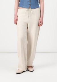 Beige, lette, linne bomullskjorter med justerbar midje, med en rett ben design og subtil tekstur.