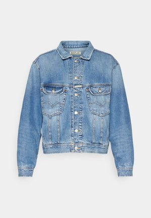 Valaisin sininen farkkutakki klassisella leikkauksella, kahdella etupussilla, napituksilla ja ommelluilla yksityiskohdilla saumoissa ja kauluksessa.