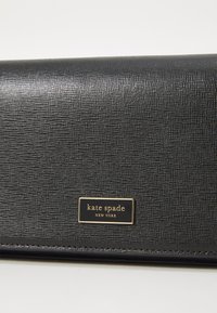 Black textured leather wallet with a gold brand plaque. Features a sleek, rectangular design and a fine, subtle pattern.
