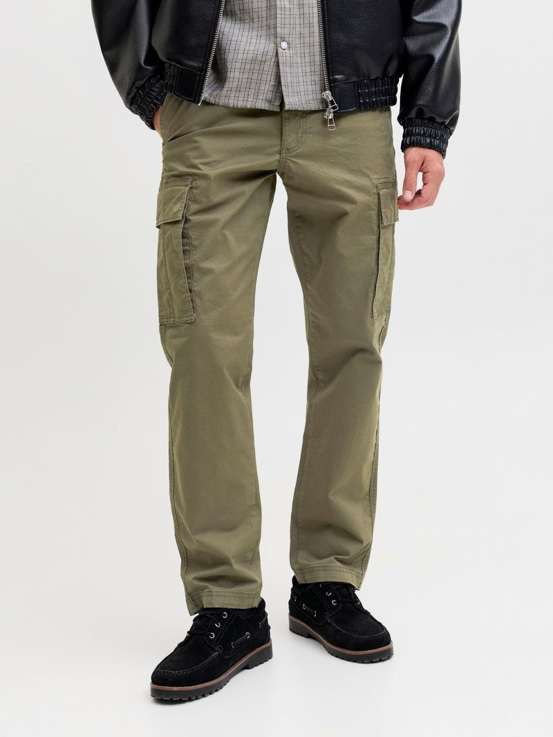 Olive green cargo pants with side pockets, a straight shape, and durable fabric. Paired with black suede shoes and a black jacket.