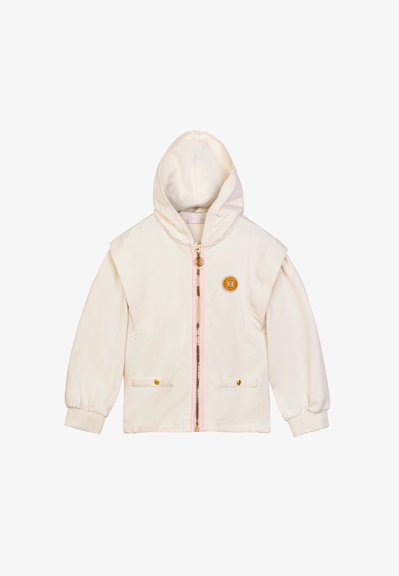 Felpa bianca con chiusura zip, dettagli della zip rosa, due tasche frontali con bottoni dorati e un'etichetta con il logo sul lato sinistro. Tessuto morbido.