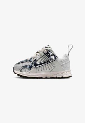 Gray athletic shoe with a textured mesh upper, glossy accents, thick white sole, and a pull tab on the heel for easy wear.