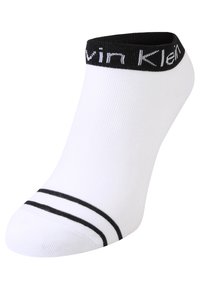 White ankle socks with a black ribbed cuff featuring the brand name. Includes two black stripes near the toe area. Smooth texture.