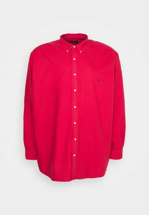 Red long-sleeve button-up shirt with collar and small blue embroidered logo on the left chest.