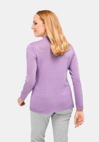 Lila Langarmpullover aus weichem Strickstoff, mit tailliertem Schnitt, gerippten Bündchen und abgerundetem Saum.