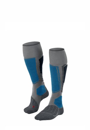 Medias altas grises y azules con puños acanalados, secciones acolchadas y talones reforzados. Confeccionadas con un material texturizado y patrones en contraste.