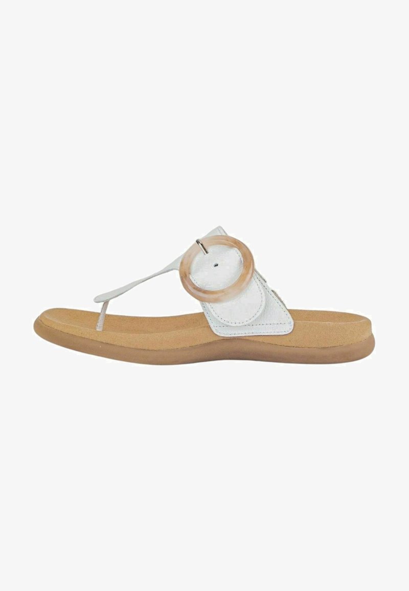 White leather sandal with a round wooden accent, flat tan sole, and thin strap design. Features a toe post for secure fit and comfort.