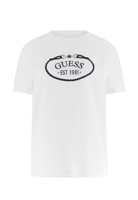 Weißes Baumwoll-T-Shirt mit kurzen Ärmeln und rundem Halsausschnitt. Verziert mit der Stickerei "GUESS EST 1981" in Marineblau innerhalb eines ovalen Seil-Designs.