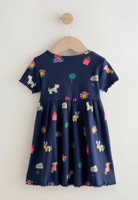 Tumszils kokvilnas kleita ar īsām piedurknēm, rotāta ar krāsainiem dzīvnieku, ziedu un formu apdrukām, ar savāktu svārku un viļņotu apakšmali.