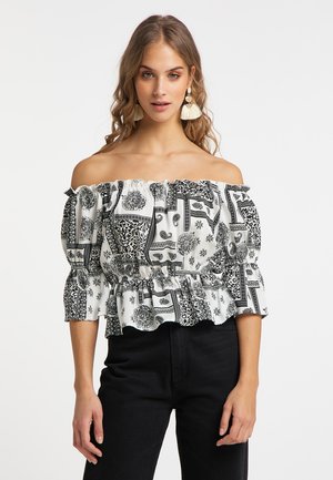 Schulterfreies Blusentop in Schwarz-Weiß mit Rüschensleeves und Peplum-Taille, das mit aufwendigen Blumen- und geometrischen Mustern verziert ist.