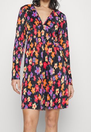 Robe florale avec un fond noir et des fleurs colorées en rouge, rose, violet et orange. Texture plissée, manches longues et décolleté en V.