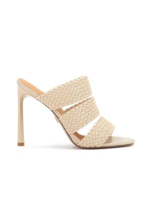 Beige heeled mules with three braided straps and a smooth, pointed toe. The heel is slender and high, featuring a subtle gold accent.