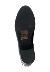 Black shoe sole with a textured grip. Features embossed care symbols and branding details in gold. Shape is slightly curved at the toe.