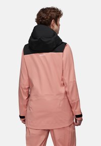Wasserdichte Outdoor-Jacke in Hellrosa mit einer schwarzen Akzentkapuze. Verfügt über verstellbare Manschetten und ein schlankes, elegantes Design.