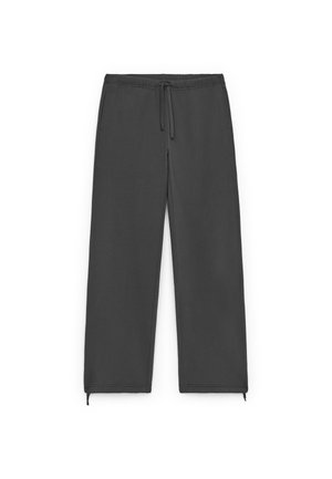 Gray sweatpants made of soft fabric, featuring an elastic waistband with a drawstring, side pockets, and zippered hems for adjusting fit.