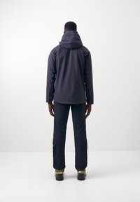 Navy waterproof jacket with a hood, paired with matching pants. Features elastic cuffs and adjustable hem, suitable for outdoor activities.