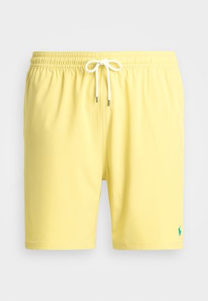 Yellow swim trunks with an elastic waistband, white drawstring, and small blue logo accent on the lower leg. Smooth fabric texture.