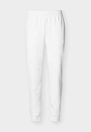 Λευκό τζόγκερ παντελόνι με ελαστική μέση, μανσέτες στα πόδια και πλαϊνές τσέπες, εμφανίζεται από μπροστά σε απλό ανοιχτό φόντο.