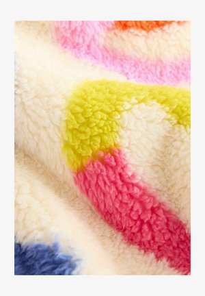 Erinevates roosa, kollase ja sinise abstraktsete kujunditega värviline pehme tekk kreemival taustal. Tekk on pehme ja karvane ning katab kogu pinna.