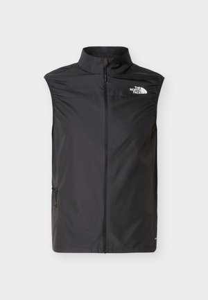 Μαύρο αμάνικο γιλέκο με φερμουάρ και ψηλό γιακά, με το λογότυπο "The North Face" στο αριστερό στήθος, τοποθετημένο σε λευκό φόντο.