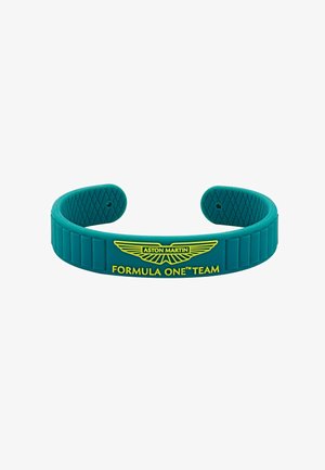 Turkooise siliconen armband met een gestructureerd binnenoppervlak, voorzien van een geel Aston Martin-logo en de tekst "FORMULA ONE™ TEAM".