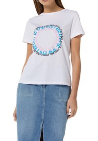 White cotton t-shirt with a circular graphic text design in black, blue, and pink, featuring the words "joyful" and "feeling." Short sleeves.