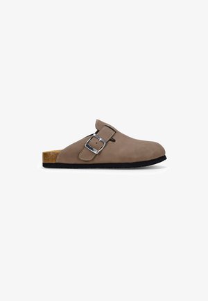 Brown suede clog with a rounded toe, adjustable silver buckle, and natural cork footbed, featuring a black rubber sole.