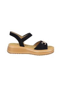 Sandali in suede nero con punta chiusa, cinturini regolabili e fibbia decorativa. Presentano una suola in piattaforma color crema con una finitura testurizzata.