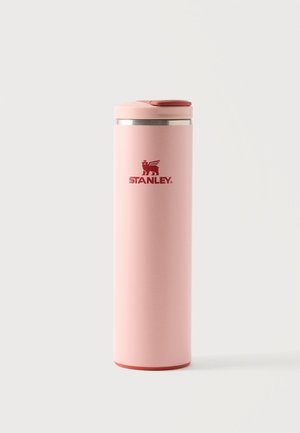 Høj lyserød isoleret Stanley rejsetermokande med flip-top låg og rød logo på en ensfarvet hvid baggrund.