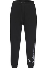 Pantaloni sport negri cu talie elastică, șnur, glezne cu mansete și design abstract alb cu linii pe partea inferioară a piciorului drept.