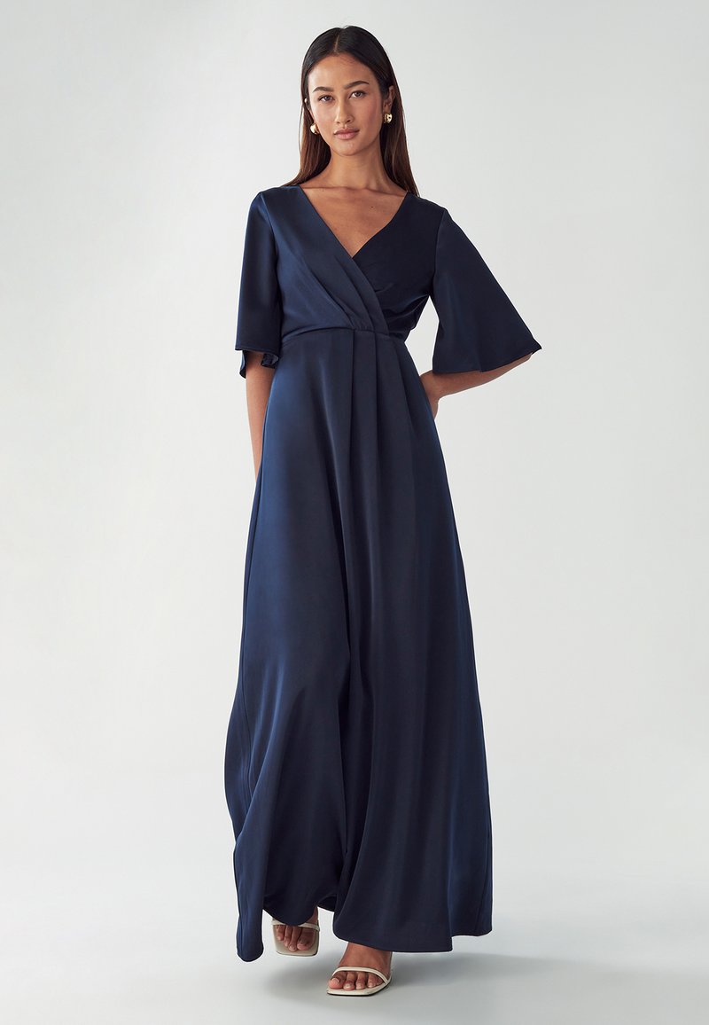 Navy blue floor-length dress made of smooth fabric, featuring a v-neckline, short flared sleeves, and a fitted waist.