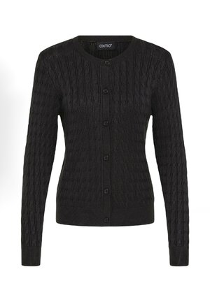 Cardigan noir en tricot avec un col rond, présentant un motif en câble texturé, des manches longues et six boutons sur le devant.