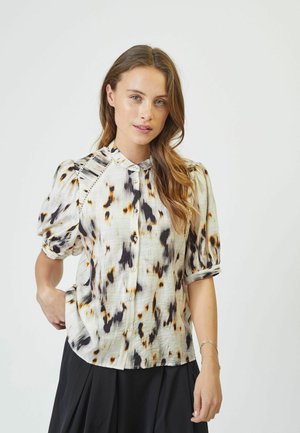 Button-up blouse in lightweight fabric featuring a cream base with black and orange abstract patterns, short puffed sleeves, and a band collar.