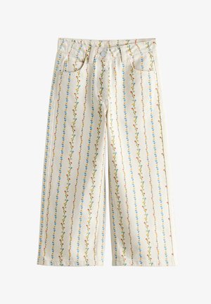 Krém széles szárú nadrág függőleges csíkokkal, kis kék, piros és sárga virágos hímzéssel és elől zsebekkel.