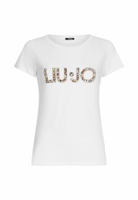 Balta medvilnė t-shirt su „LIU:JO“ logotipu stilizuotu, margu spausdinimu ir dekoratyviniais akcentais, trumpomis rankovėmis. Apvalus iškirpimas.