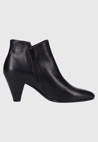Bottine en cuir noir avec fermeture éclair latérale, bout pointu et talon moyen empilé, présentée sur un fond gris clair uni.