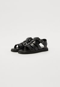 Black sandals with multiple wide straps, an open toe design, and a rear ankle strap. Rubber sole for grip and comfort.