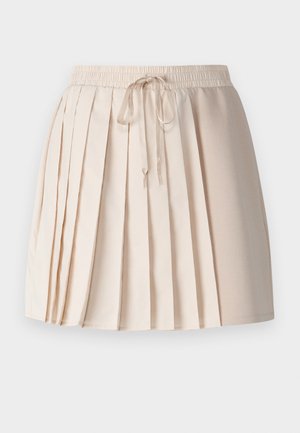 Heled pleediga seelik heledas beežis, valmistatud pehmest kangast. Omab elastset vöökohta ja sidumisnööri ning vertikaalseid pleateid tekstuuri jaoks.