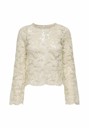Top de manga larga de encaje en beige claro con bordado floral, escote redondo y dobladillo en forma de dientes de sierra. Textura semi-translúcida.