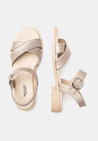 Metallisch goldene Sandalen mit Überkreuzriemen und einem gepolsterten Knöchelriemen mit Schnalle. Sie haben einen leichten Absatz und eine gepolsterte Innensohle mit durchbrochenen Details.
