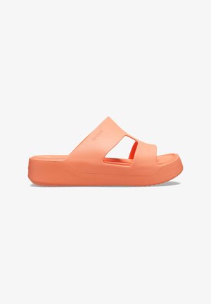 Perzikkleurige platform slide sandalen met een gladde, rubberachtige textuur, voorzien van open zijkanten en een ronde neusontwerp.