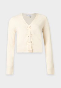 Cardigan court à manches longues de couleur crème avec col en V et quatre petits nœuds décoratifs le long de la fermeture devant.