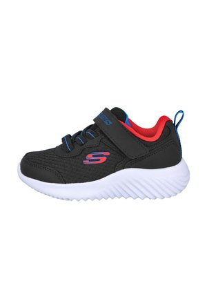 Zapato deportivo negro con parte superior de malla, forro rojo, acentos azules y suela de goma blanca con un dibujo texturizado. Correa de velcro y cordones.