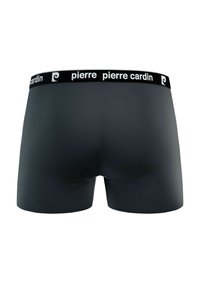 Boxer-culottes noires avec une texture lisse, dotées d'une large ceinture de marque en noir et blanc, et d'une coupe ajustée.